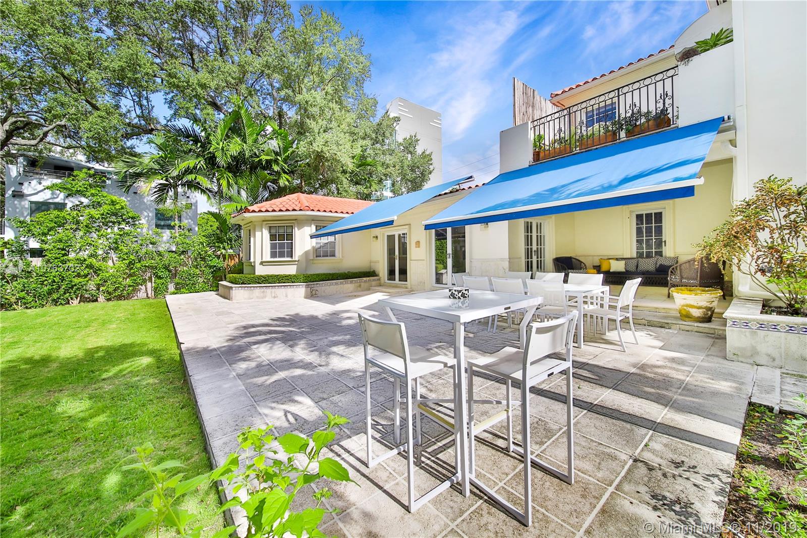 244 Southwest 28th Road Miami, FL 33129 - Photo 21 of 43 a view of a patio with table and chairs potted plants and large tree