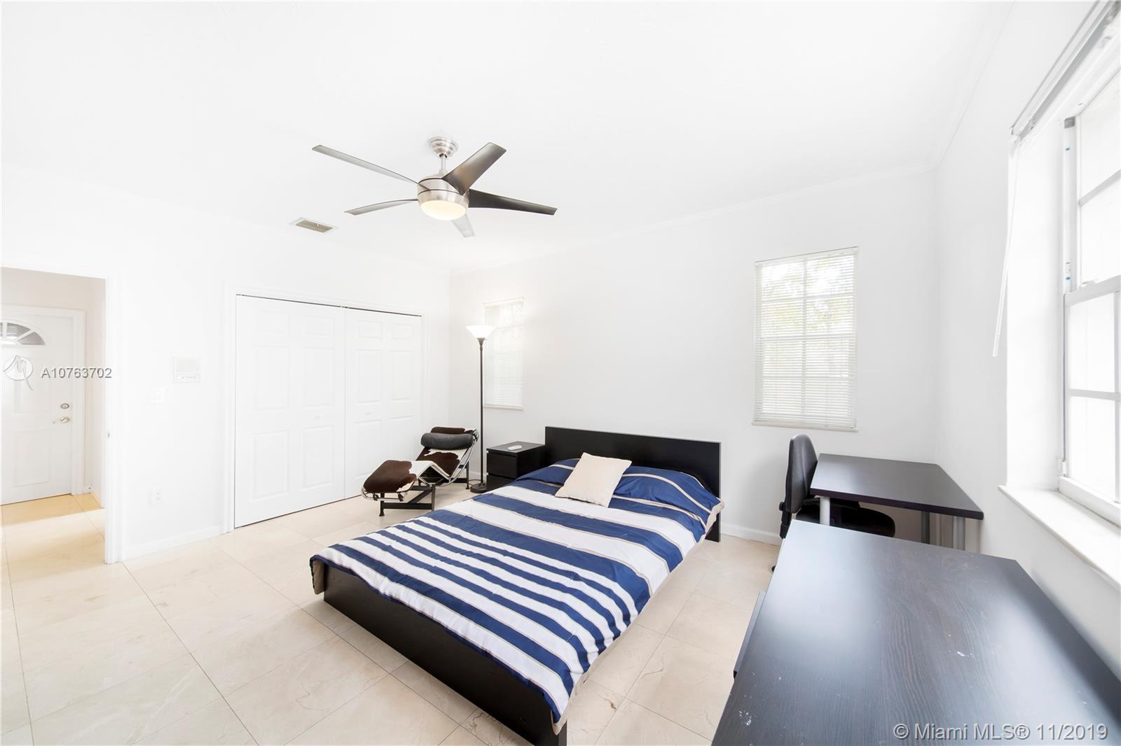 244 Southwest 28th Road Miami, FL 33129 - Photo 25 of 43 a bedroom with a bed and a window