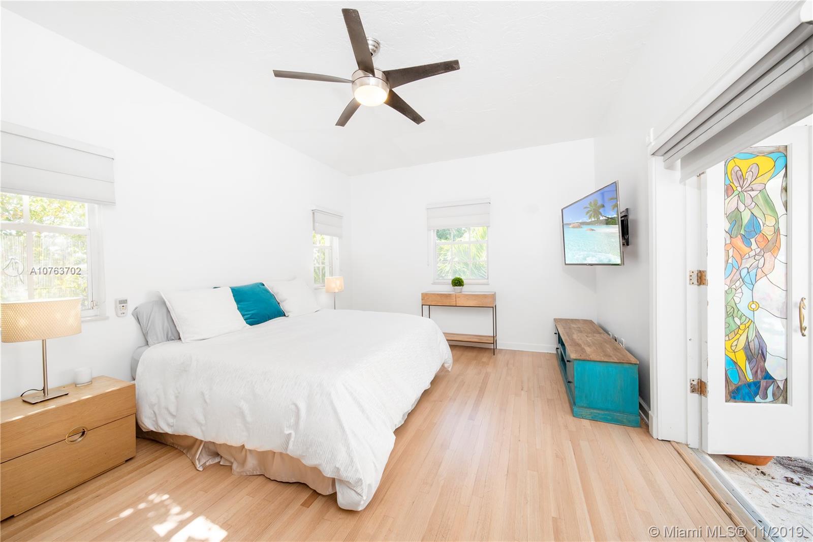 244 Southwest 28th Road Miami, FL 33129 - Photo 28 of 43 a spacious bedroom with a bed and a dresser
