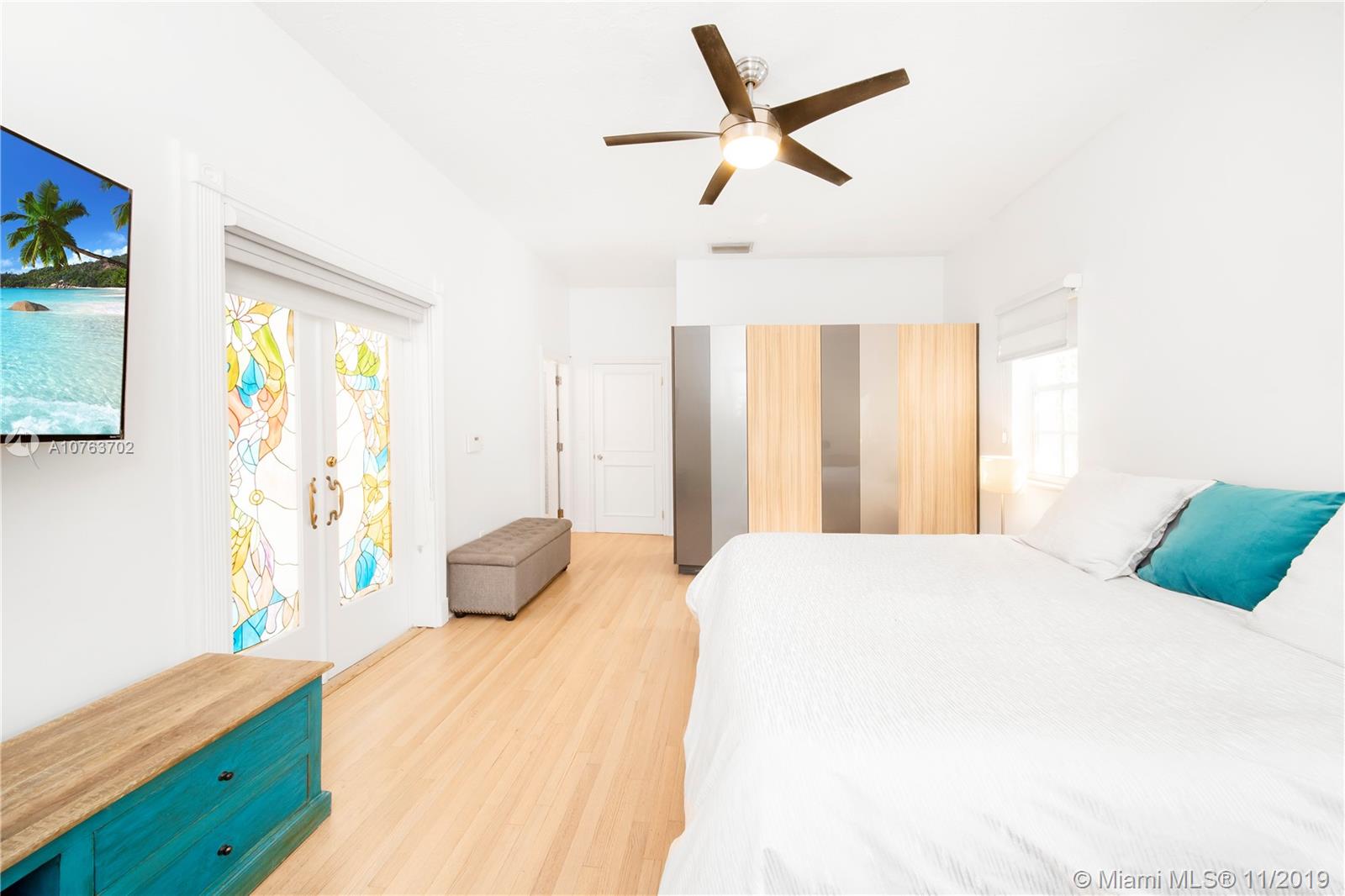 244 Southwest 28th Road Miami, FL 33129 - Photo 29 of 43 a bedroom with a bed and wooden floor