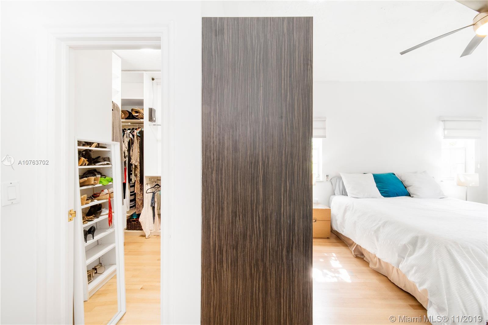 244 Southwest 28th Road Miami, FL 33129 - Photo 32 of 43 a bedroom with a bed and a book shelf