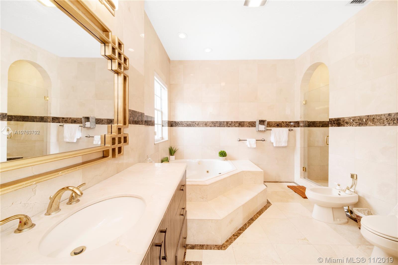 244 Southwest 28th Road Miami, FL 33129 - Photo 34 of 43 a spacious bedroom with a bed and a large window