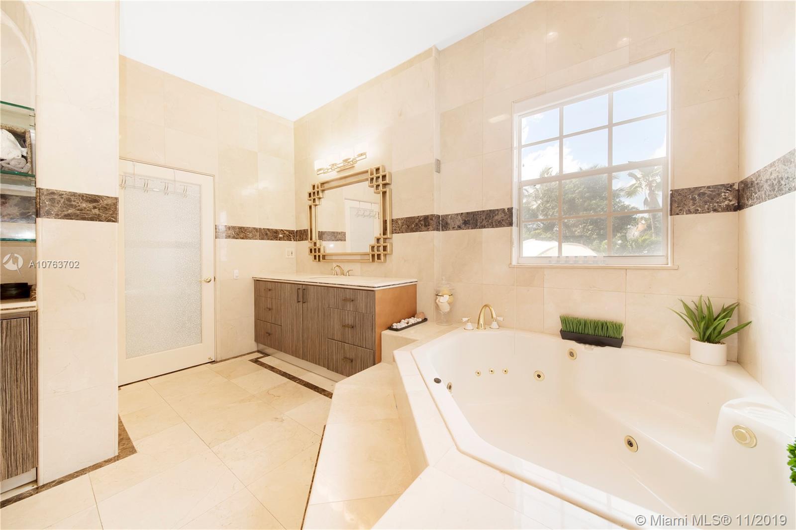 244 Southwest 28th Road Miami, FL 33129 - Photo 37 of 43 a bathroom with a tub sink and mirror