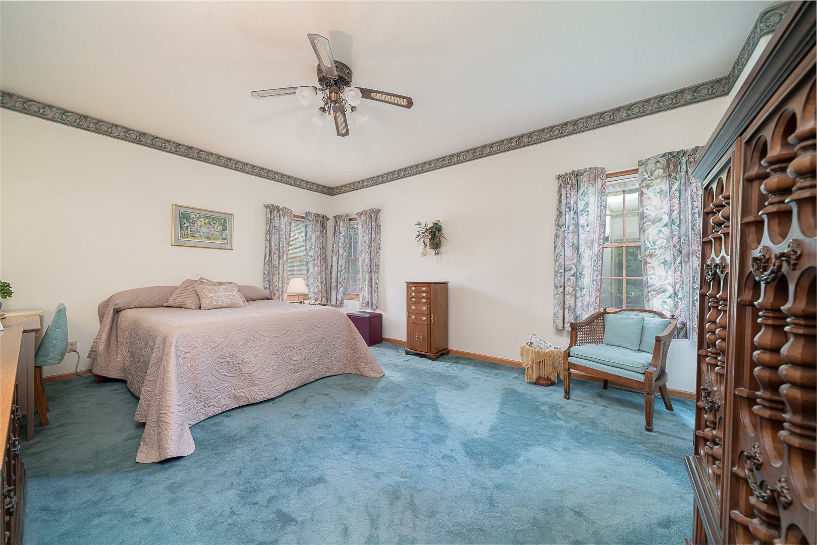 1901 Wildcat Road Dixon, IL 61021 - Photo 15 of 49 a spacious bedroom with a bed and a chandelier