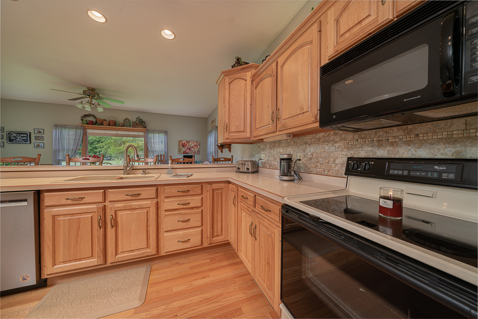 1901 Wildcat Road Dixon, IL 61021 - Photo 10 of 49 a kitchen with stainless steel appliances granite countertop a sink stove and microwave