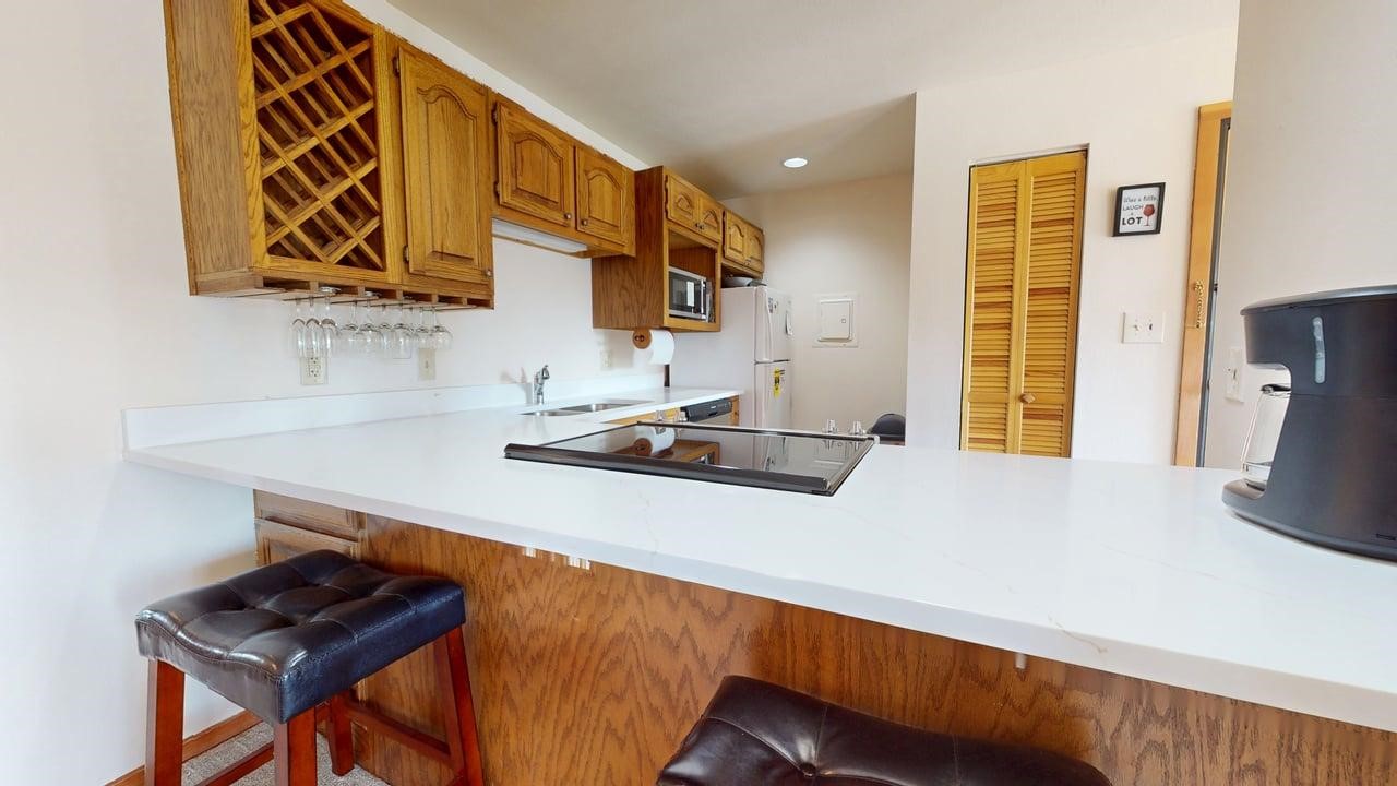 91200 Ryan Gulch Road, Unit 213 Silverthorne, CO 80498 - Photo 11 of 33 a kitchen with stainless steel appliances a sink a stove and a refrigerator