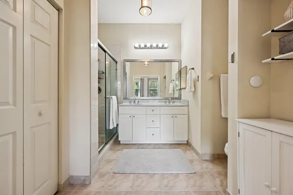 a bathroom with a sink a mirror and a shower
