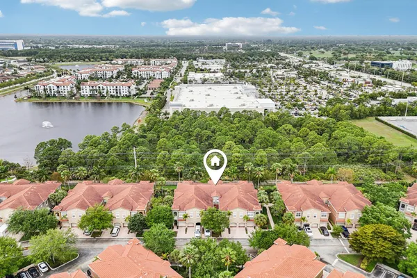 an aerial view of residential houses with outdoor space and river