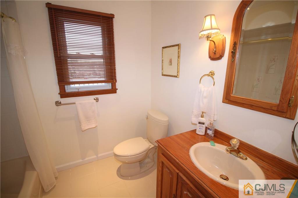 25 Montview Road Edison, NJ 08837 - Photo 13 of 21 a bathroom with a sink and mirror with toilet