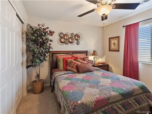 a bedroom with a bed and a potted plant