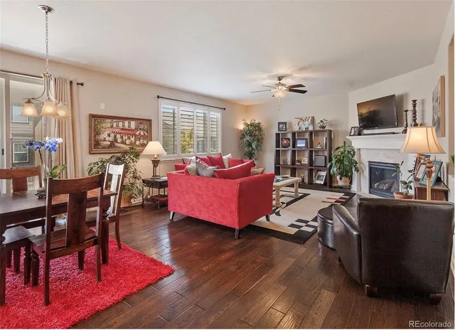 a living room with furniture a flat screen tv and a table