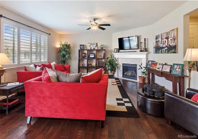 a living room with furniture fireplace and flat screen tv