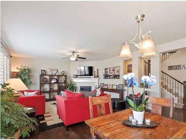 a living room with furniture kitchen view and a chandelier