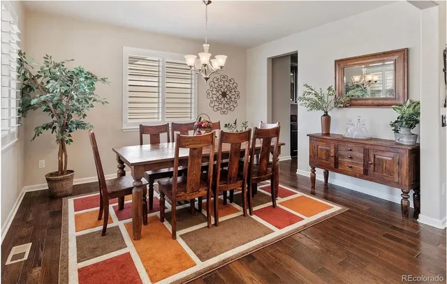 a view of a dining room with furniture and window