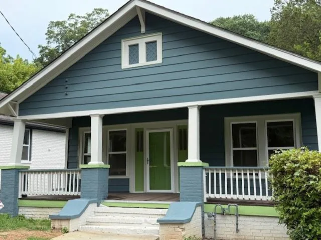 a view of a house with a wooden deck