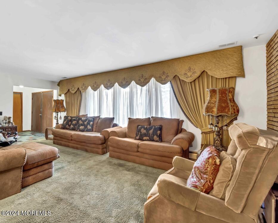 109 Crine Road Morganville, NJ 07751 - Photo 11 of 26 a living room with furniture a couch and a large window