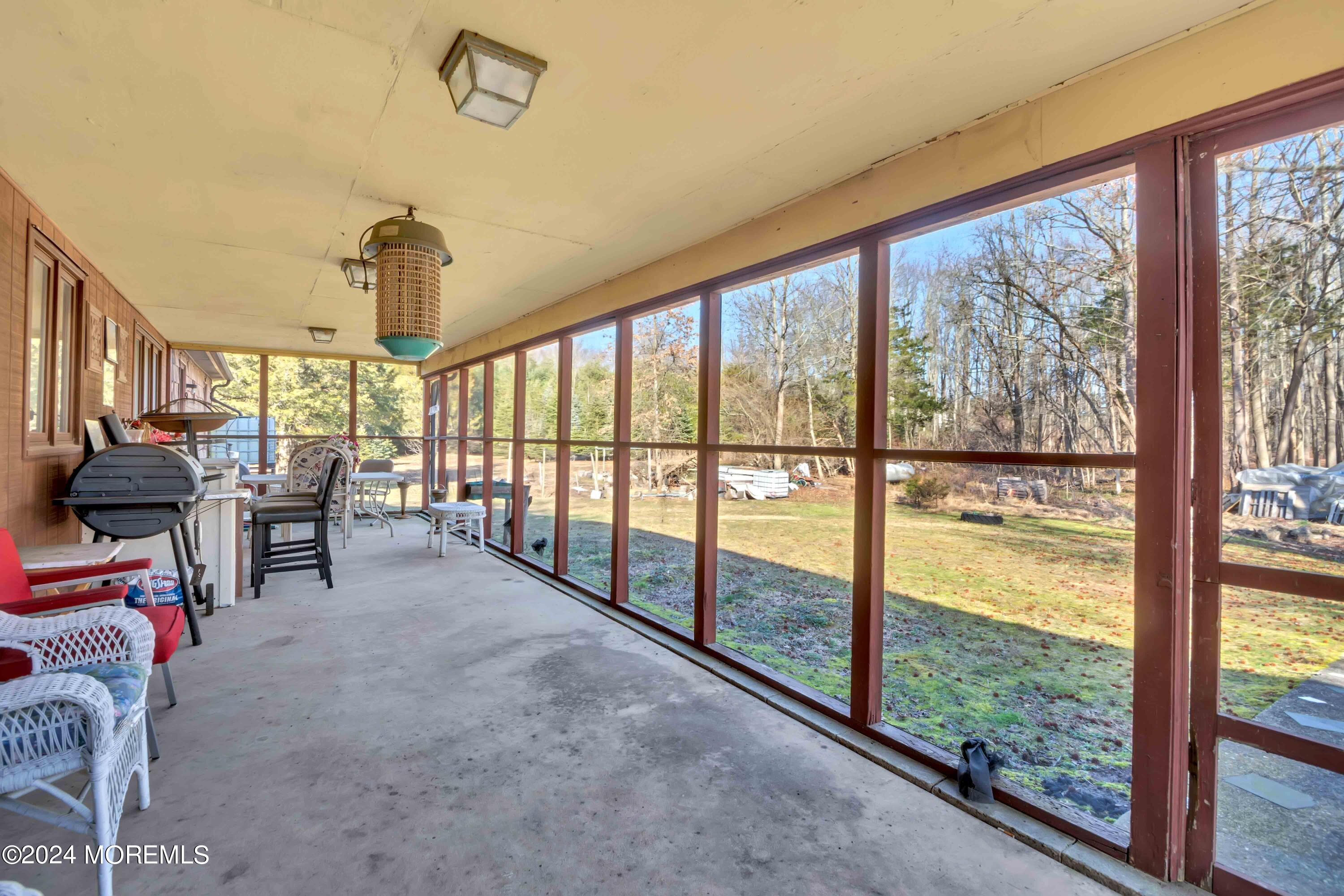109 Crine Road Morganville, NJ 07751 - Photo 15 of 26 a view of a livingroom with furniture and floor to ceiling window