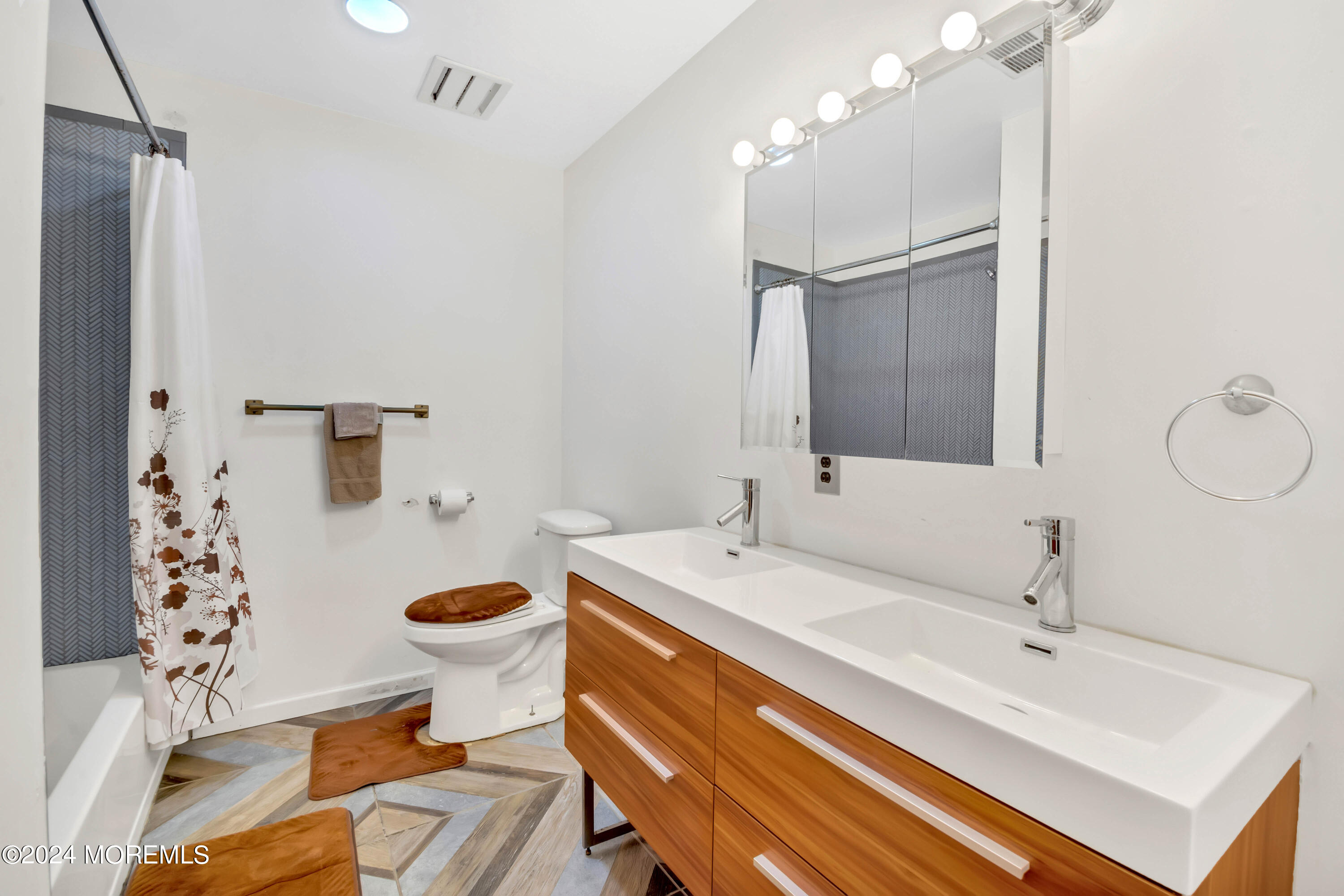 109 Crine Road Morganville, NJ 07751 - Photo 16 of 26 a bathroom with a sink toilet and shower