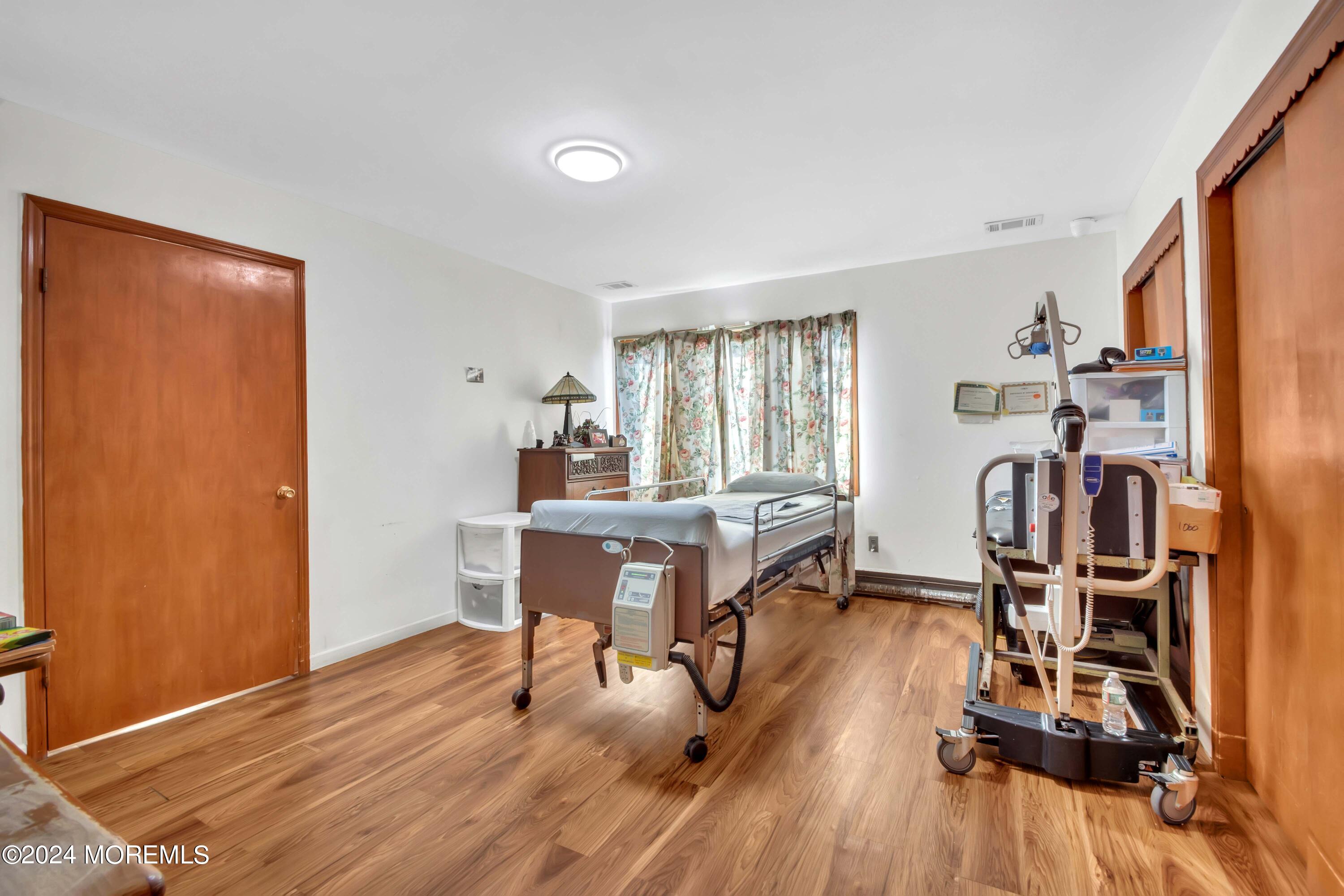 109 Crine Road Morganville, NJ 07751 - Photo 19 of 26 a view of a workspace with furniture and wooden floor