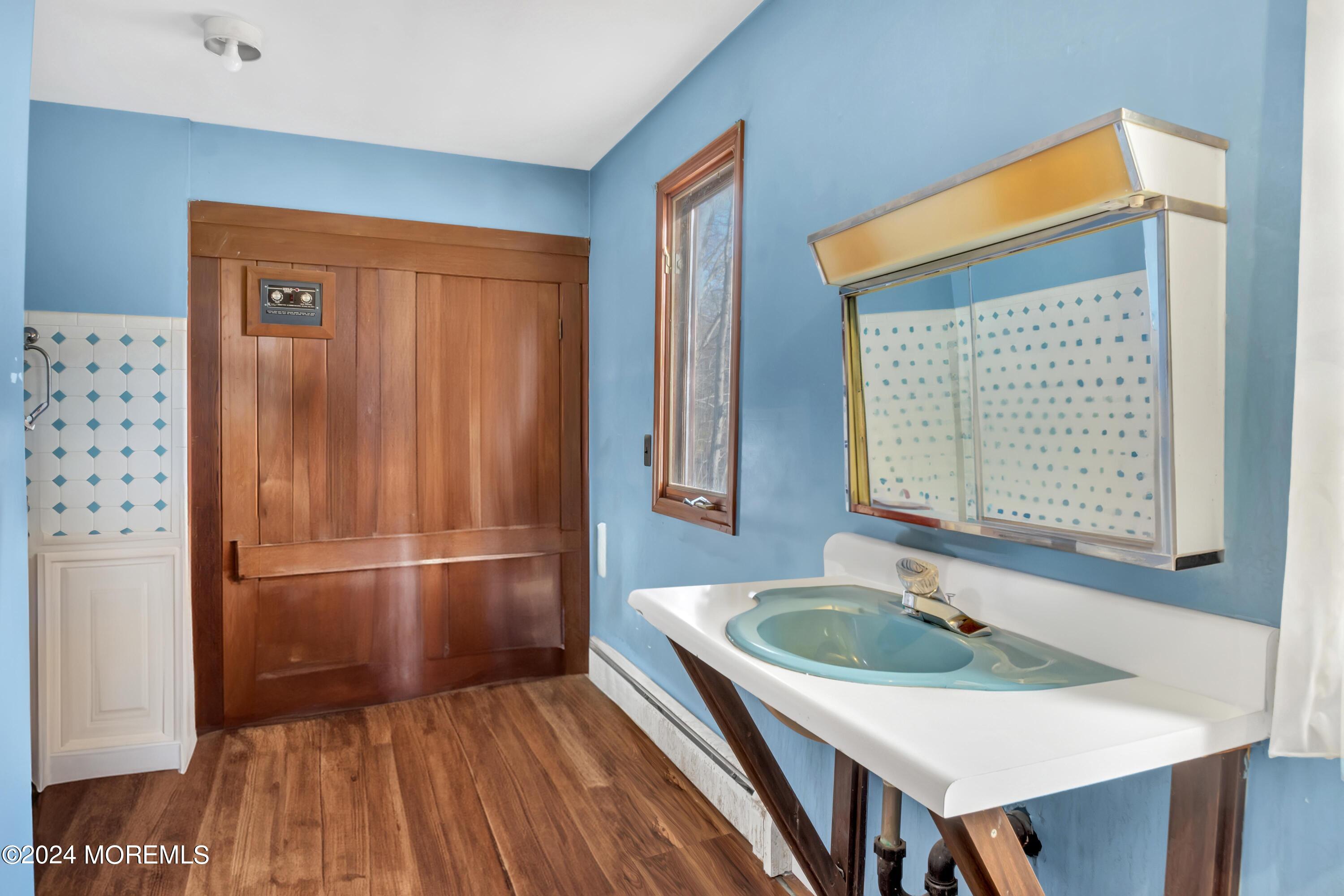 109 Crine Road Morganville, NJ 07751 - Photo 20 of 26 a kitchen with a refrigerator and a sink