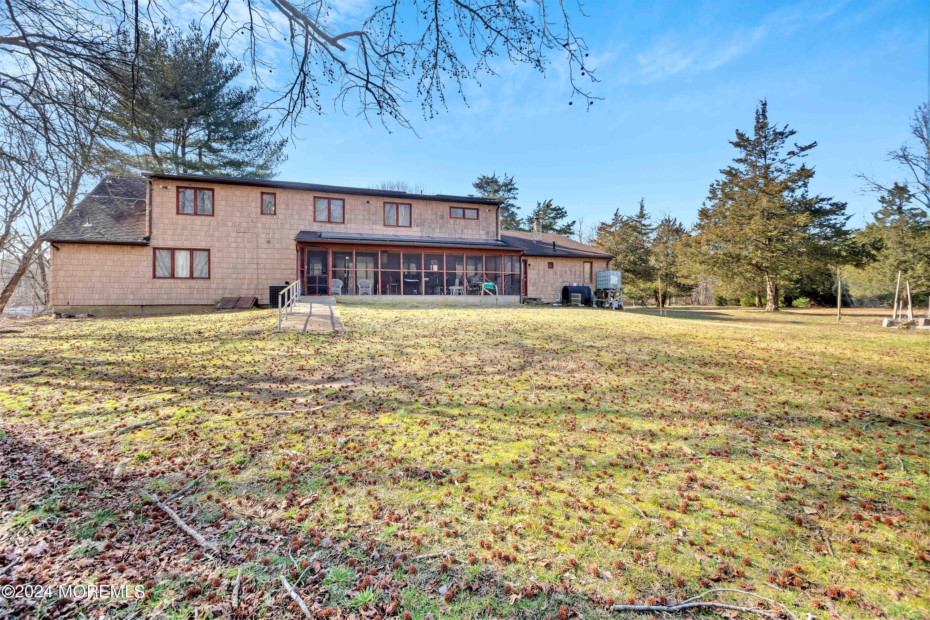 109 Crine Road Morganville, NJ 07751 - Photo 25 of 26 a view of a house with a yard and tree s