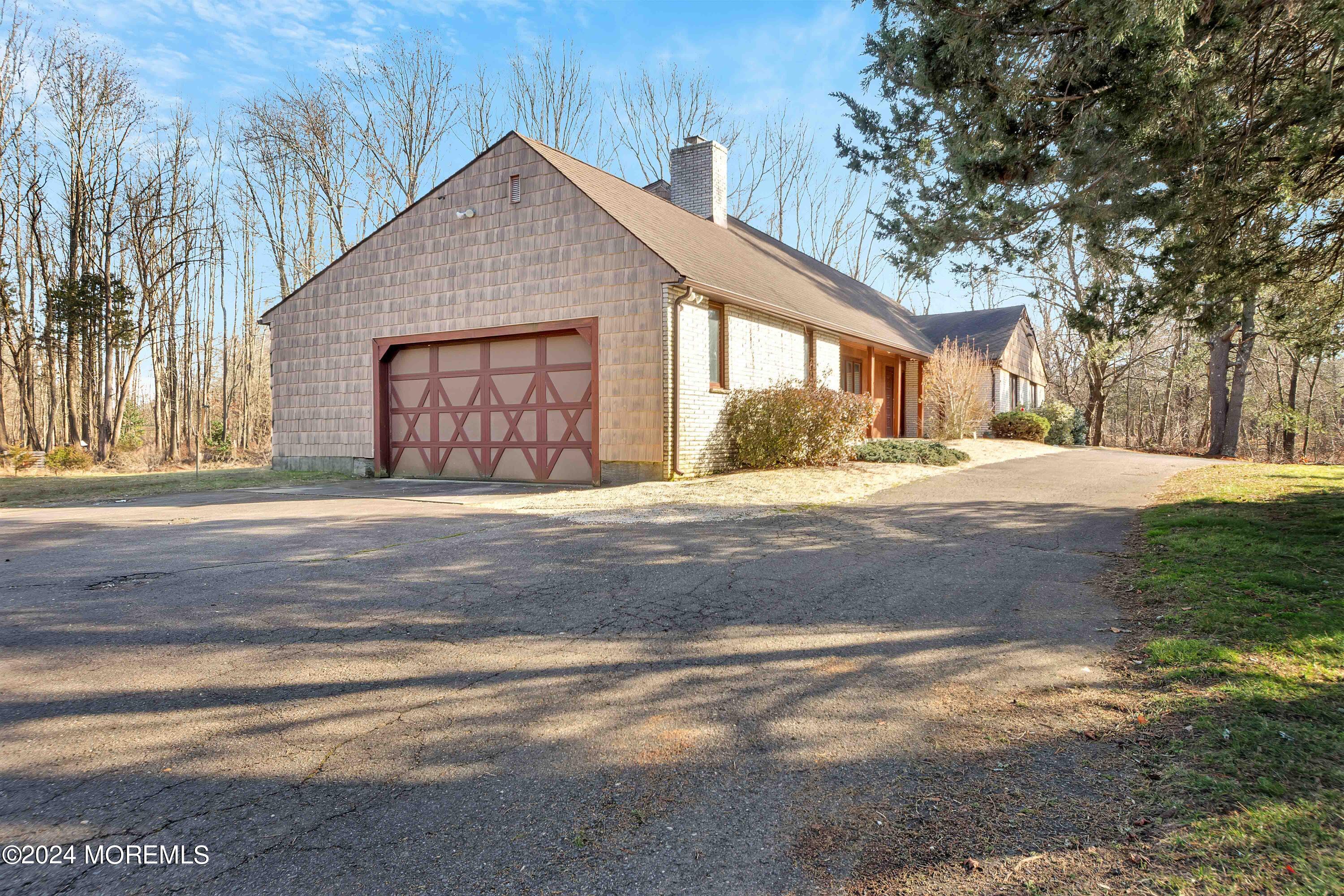 109 Crine Road Morganville, NJ 07751 - Photo 8 of 26 a front view of a house with a yard and garage