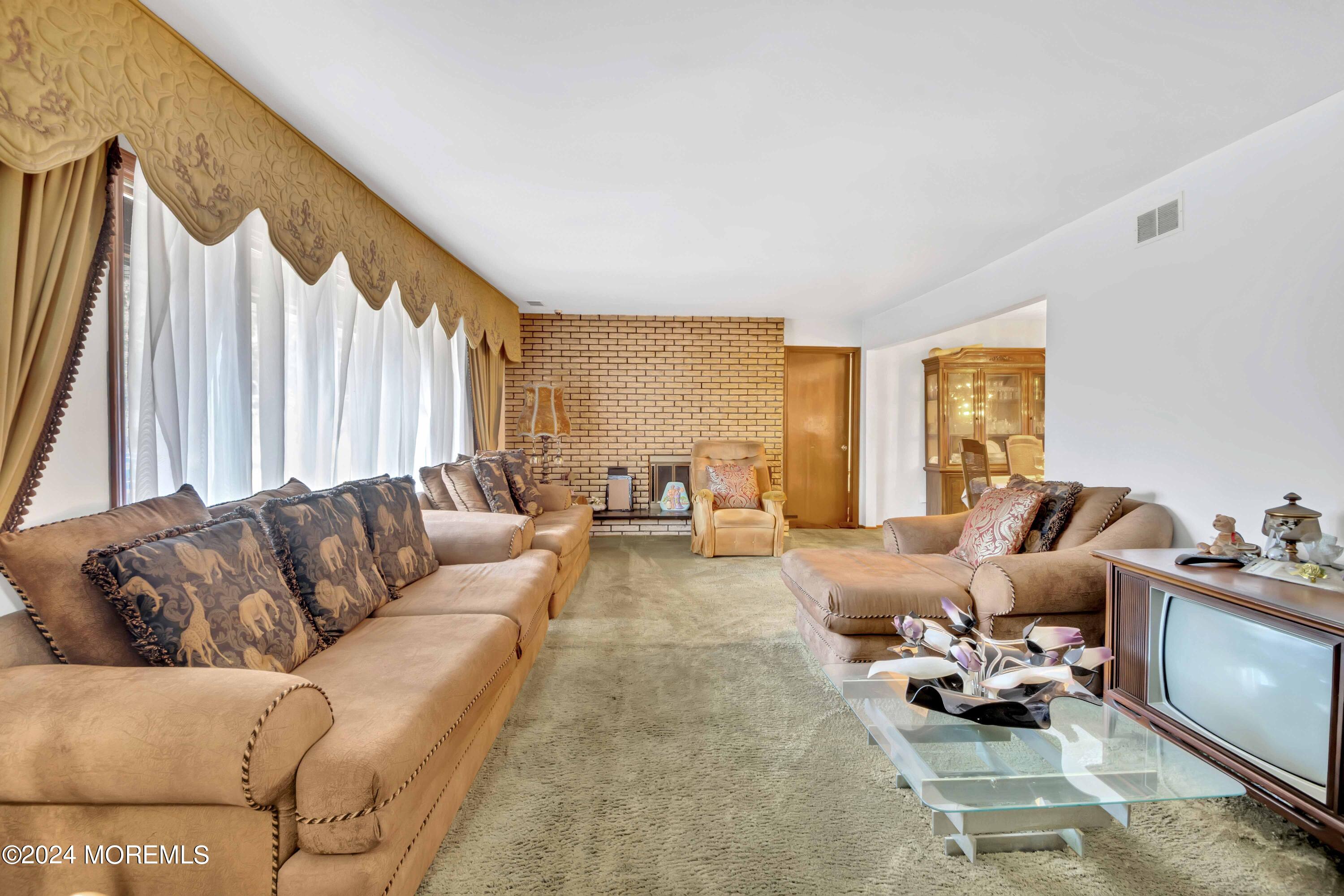 109 Crine Road Morganville, NJ 07751 - Photo 10 of 26 a living room with furniture and a large window