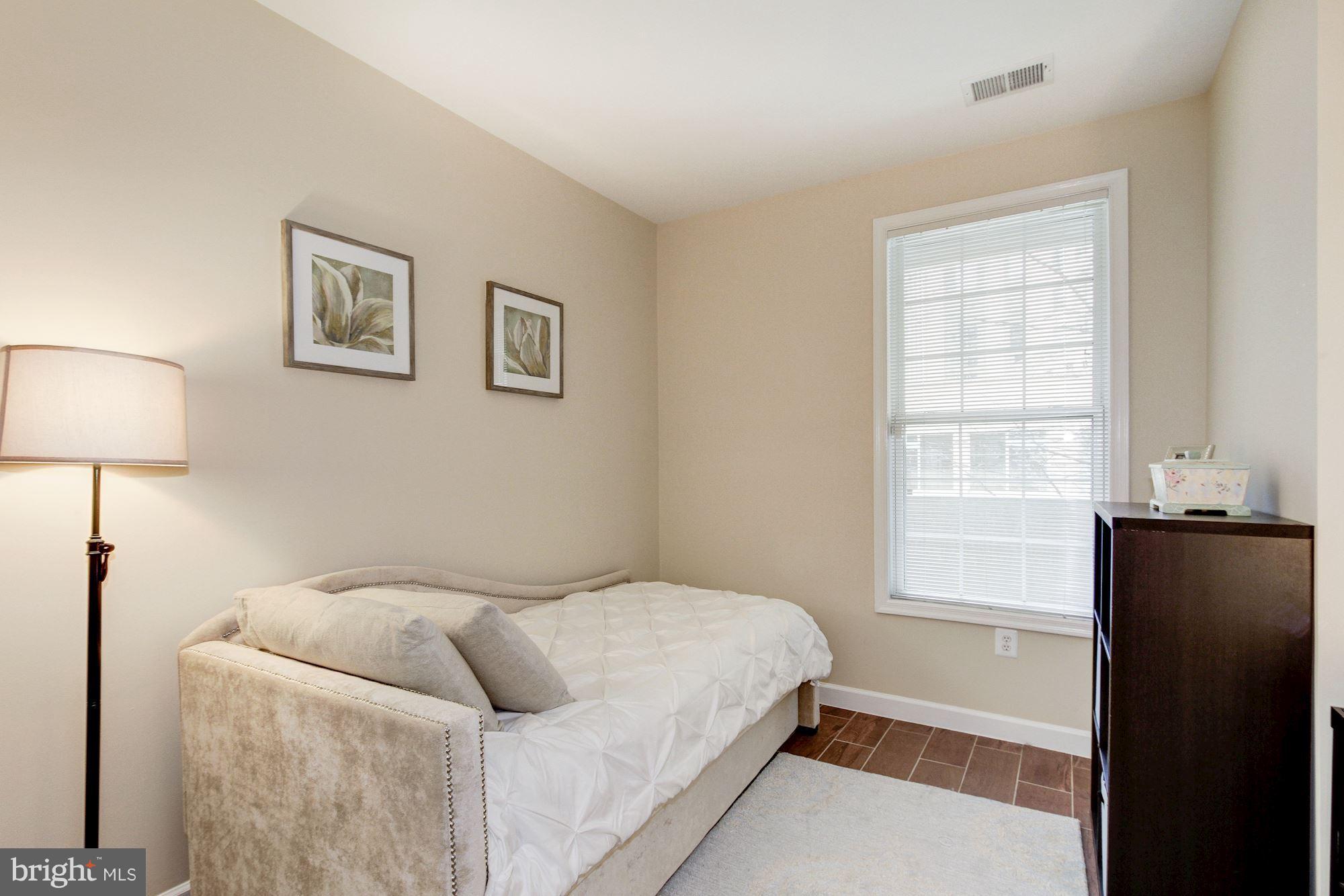 2310 14th Street North, Unit 108 Arlington, VA 22201 - Photo 14 of 22 a bedroom with a bed and a window