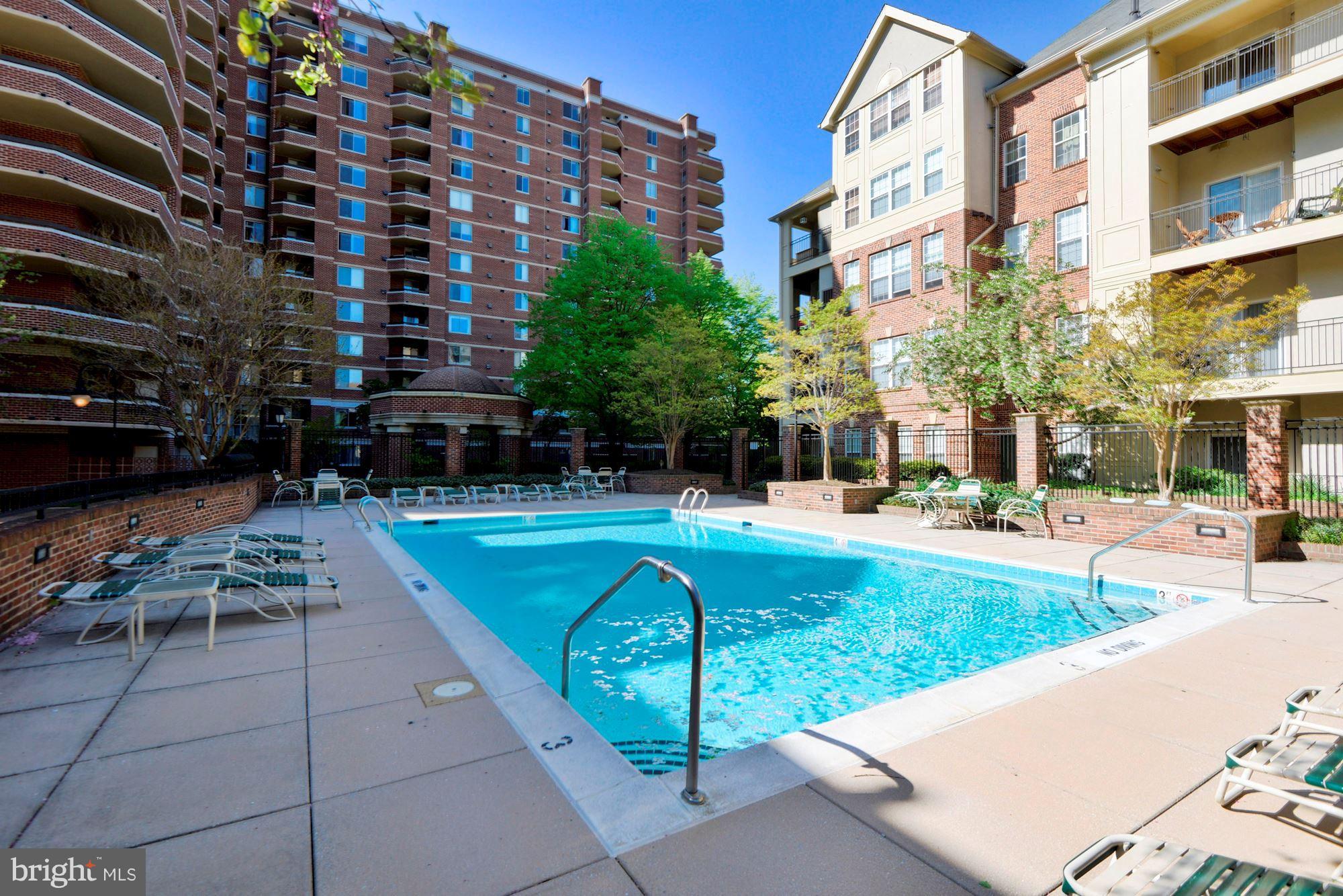2310 14th Street North, Unit 108 Arlington, VA 22201 - Photo 19 of 22 a view of a swimming pool with a lounge chair