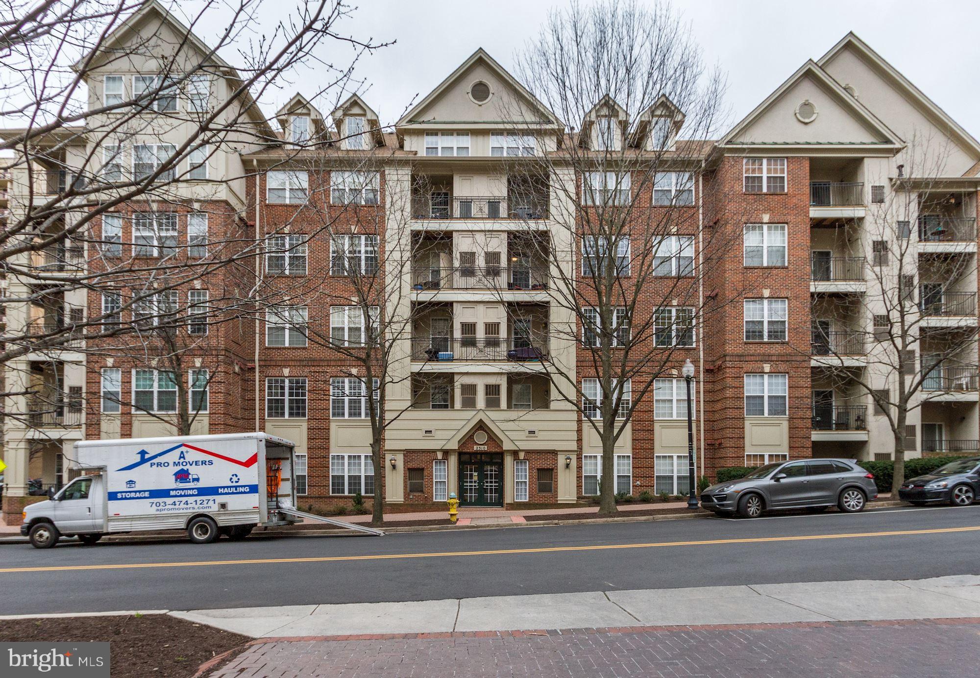 2310 14th Street North, Unit 108 Arlington, VA 22201 - Photo 2 of 22 a view of a parked cars in front of a building