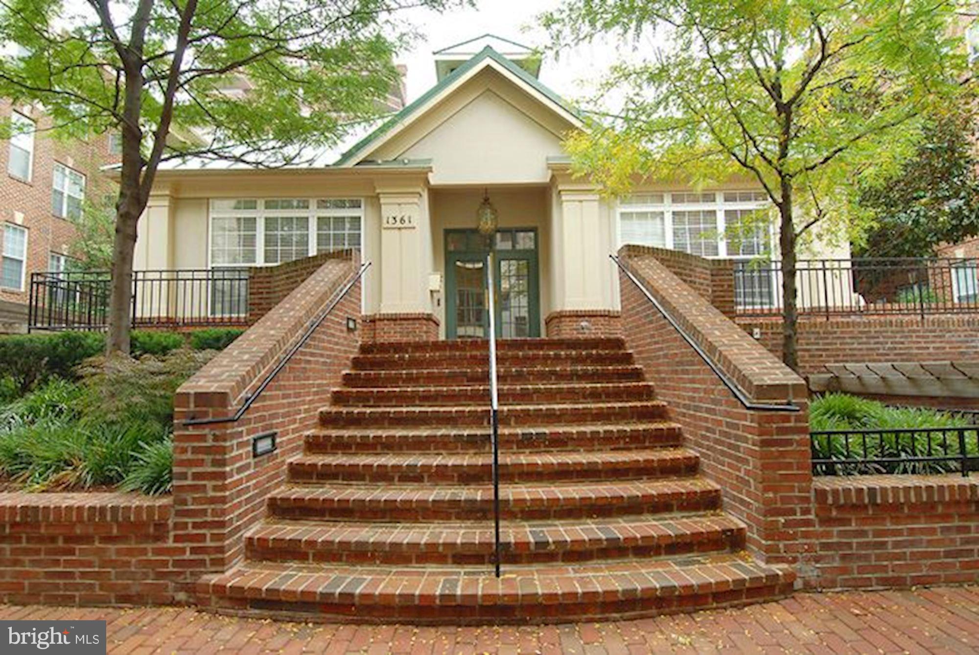 2310 14th Street North, Unit 108 Arlington, VA 22201 - Photo 21 of 22 a view of a house with wooden fence and large trees
