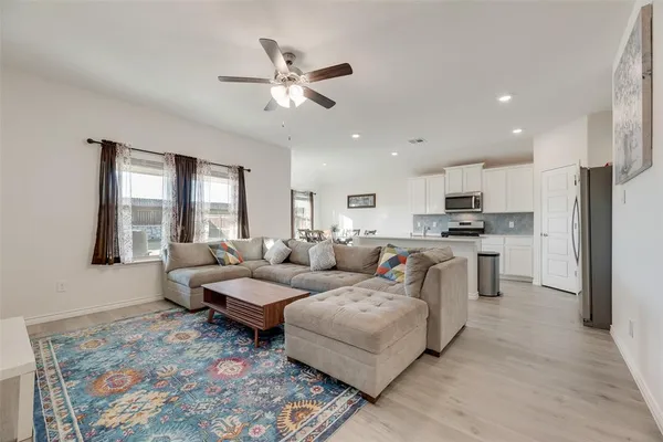 a kitchen with a table chairs and white appliances