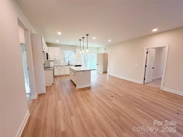 a view of kitchen with wooden floor and electronic appliances