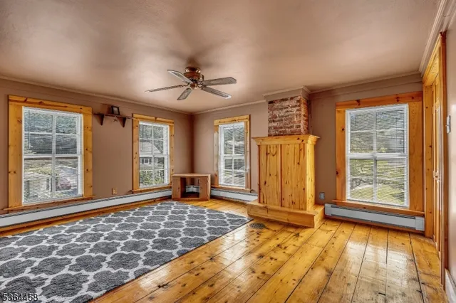 wooden floor in an empty room with a window