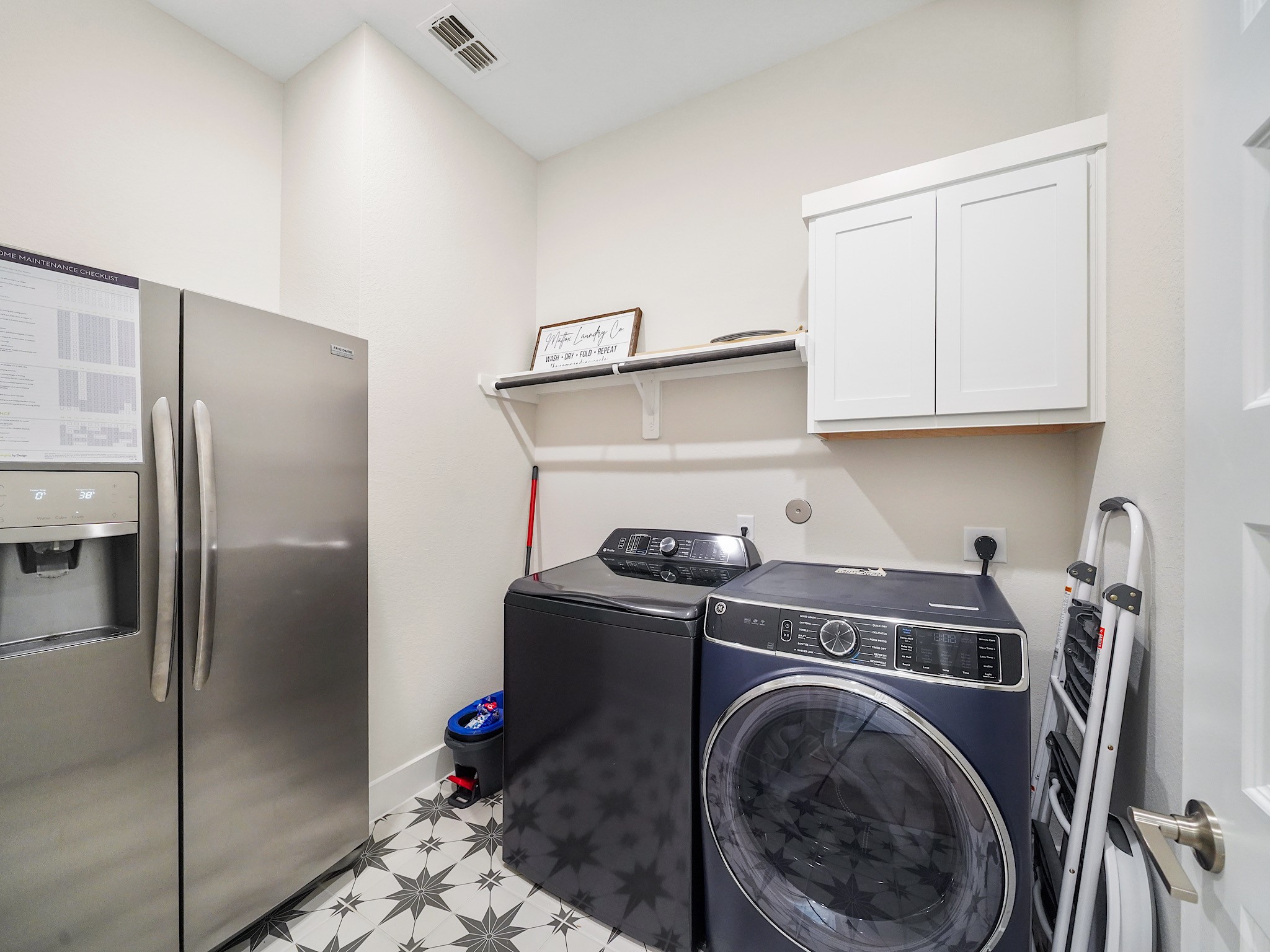 5802 Emerald Ranch Lane Fulshear, TX 77441 - Photo 28 of 45 The spacious utility room provides additional storage potential with ample cabinetry, generous workspace, and room for organization to keep daily routines running smoothly.