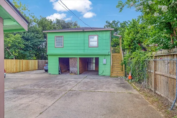 a view of a house with a yard and potted plants