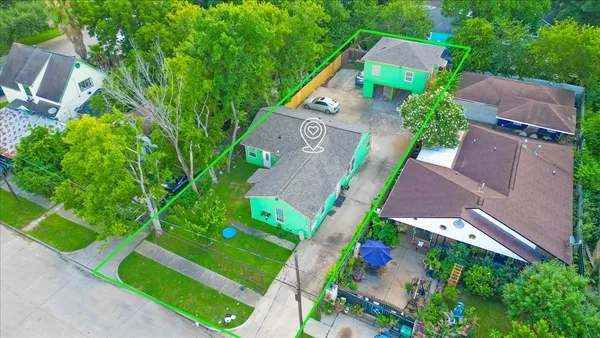 an aerial view of residential houses with outdoor space and street view