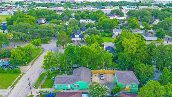 an aerial view of a house with a yard and a bench
