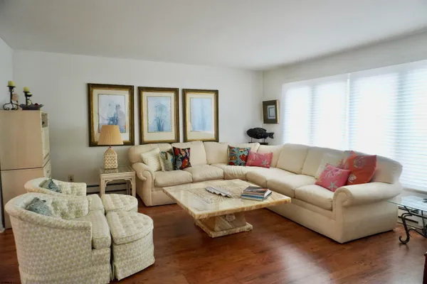 a living room with furniture and wooden floor