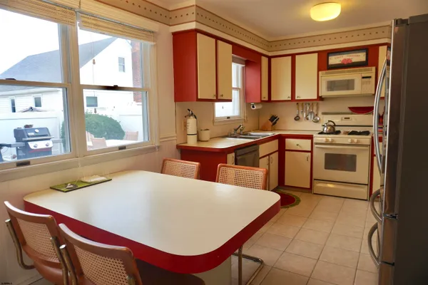 a kitchen with stainless steel appliances granite countertop a refrigerator sink and cabinets