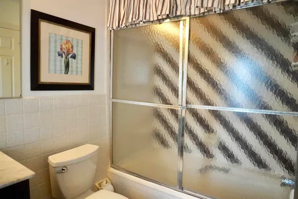 a bathroom with a toilet a sink and a mirror