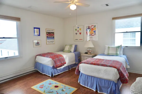 a view of a white house with a table and chairs