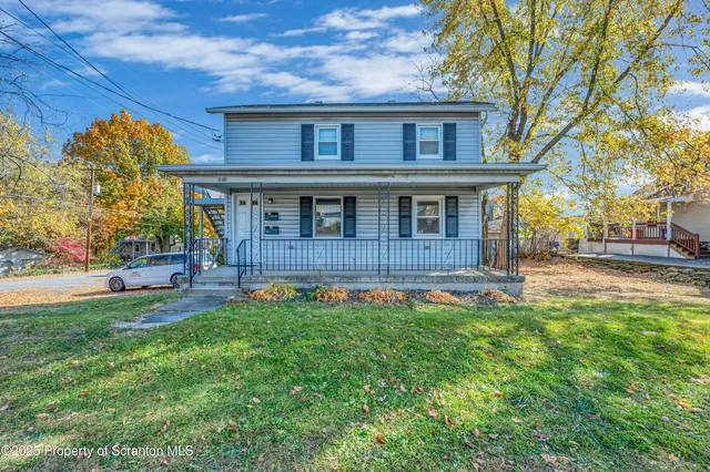 front view of a house with a big yard