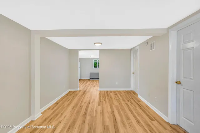 a view of a room with wooden floor staircase and a bathroom