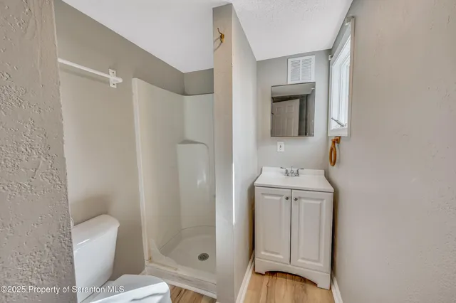 a bathroom with a toilet a sink and shower