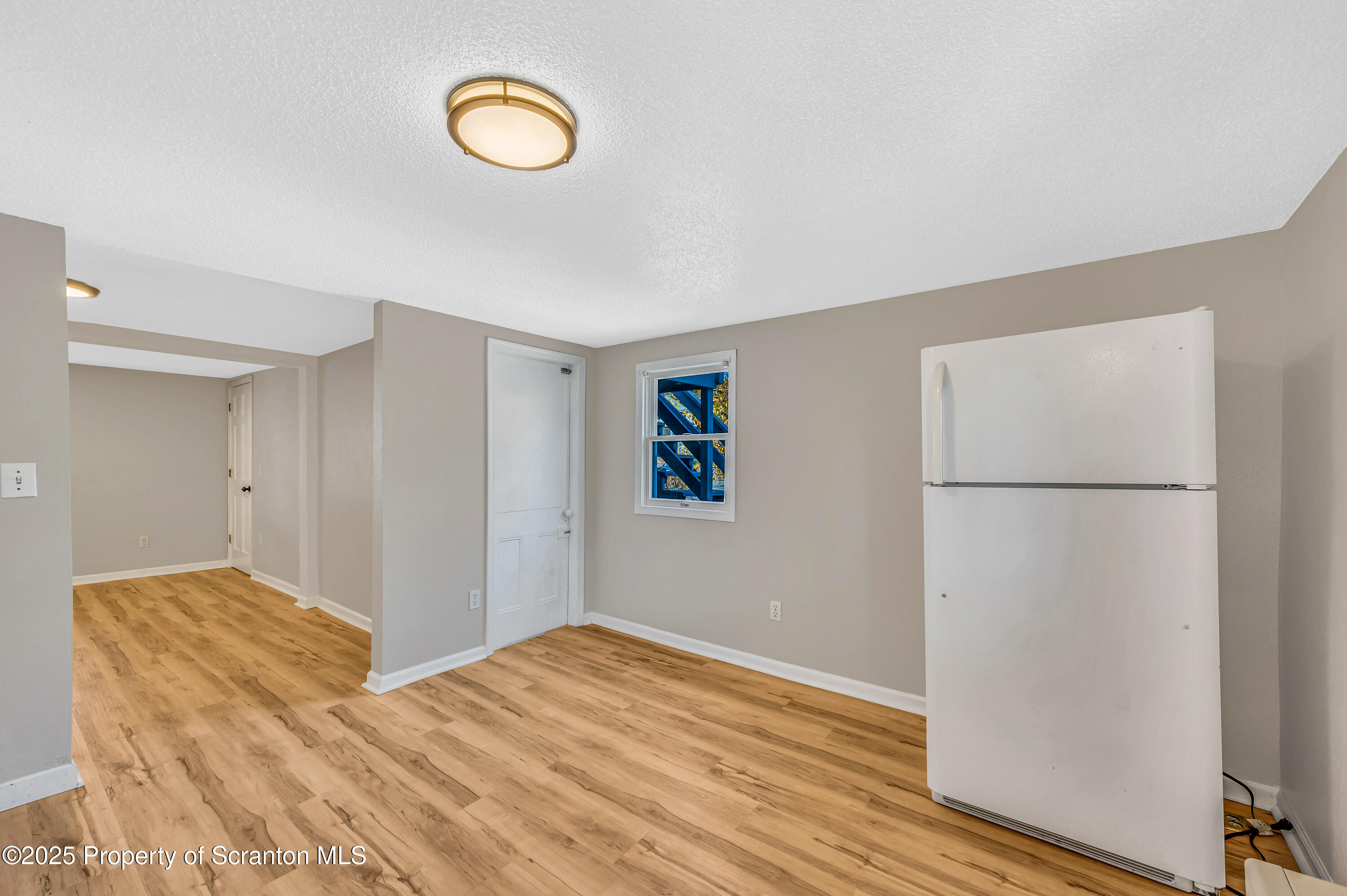 1120 Prescott Avenue, Unit 1 Dunmore, PA 18510 - Photo 7 of 16 a view of a room with wooden floor and window