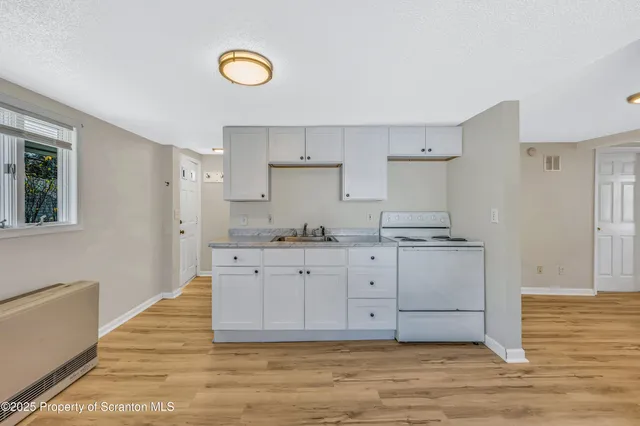 a kitchen with granite countertop white cabinets and a granite counter tops
