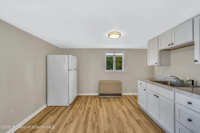 a spacious bathroom with a sink and a mirror