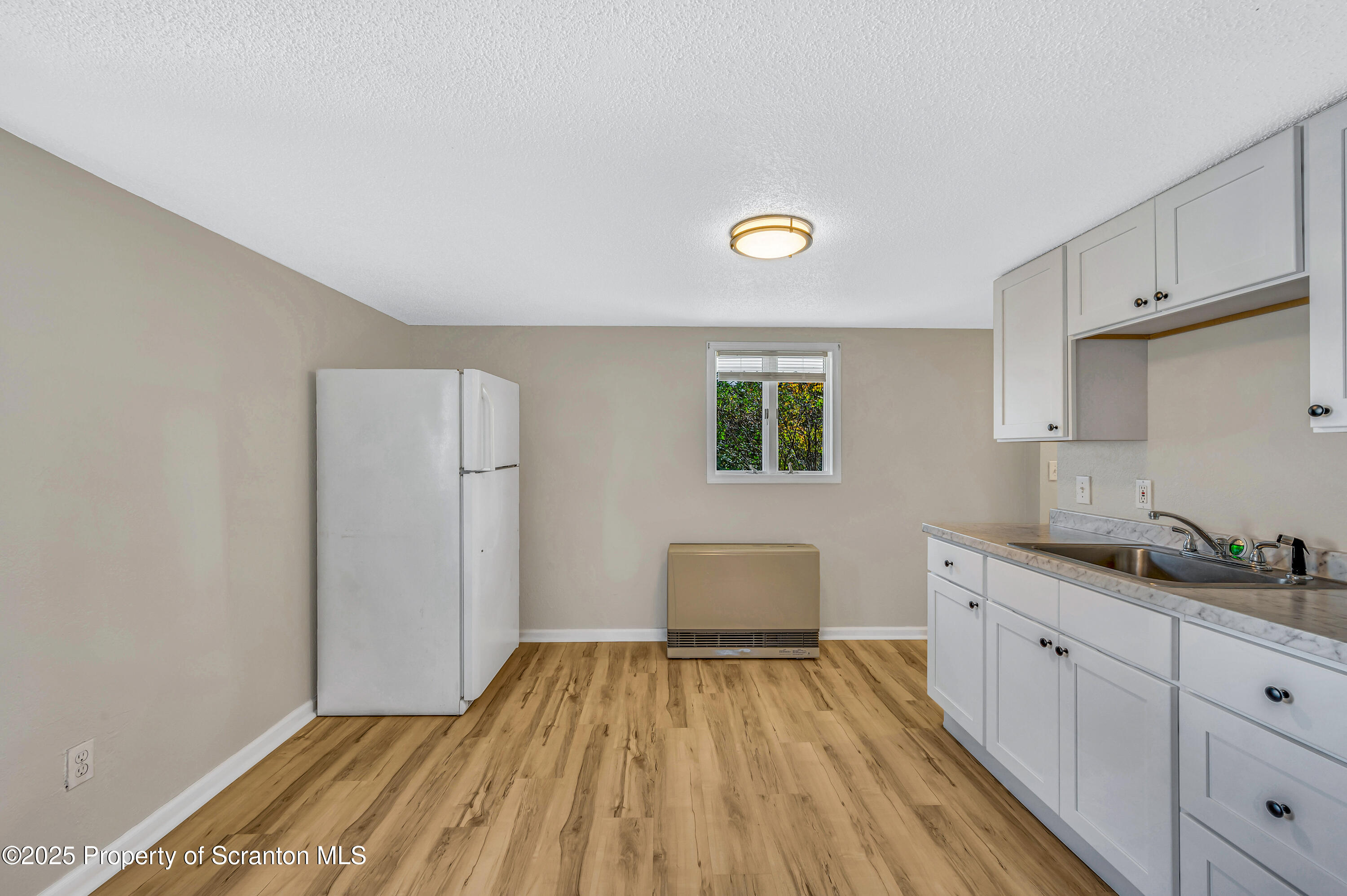 1120 Prescott Avenue, Unit 1 Dunmore, PA 18510 - Photo 10 of 16 a spacious bathroom with a sink and a mirror