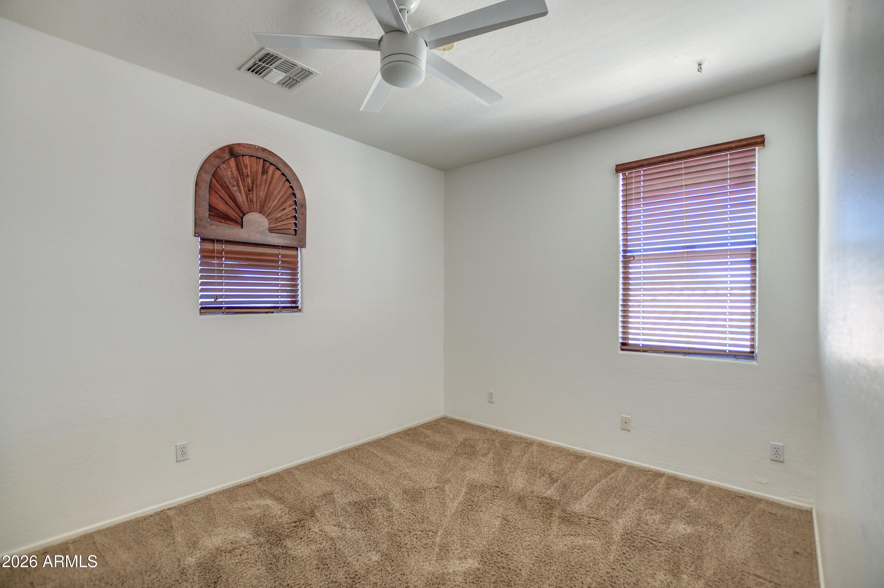 3078 East Muirfield Street Gilbert, AZ 85298 - Photo 73 of 92 an empty room with a ceiling fan and window